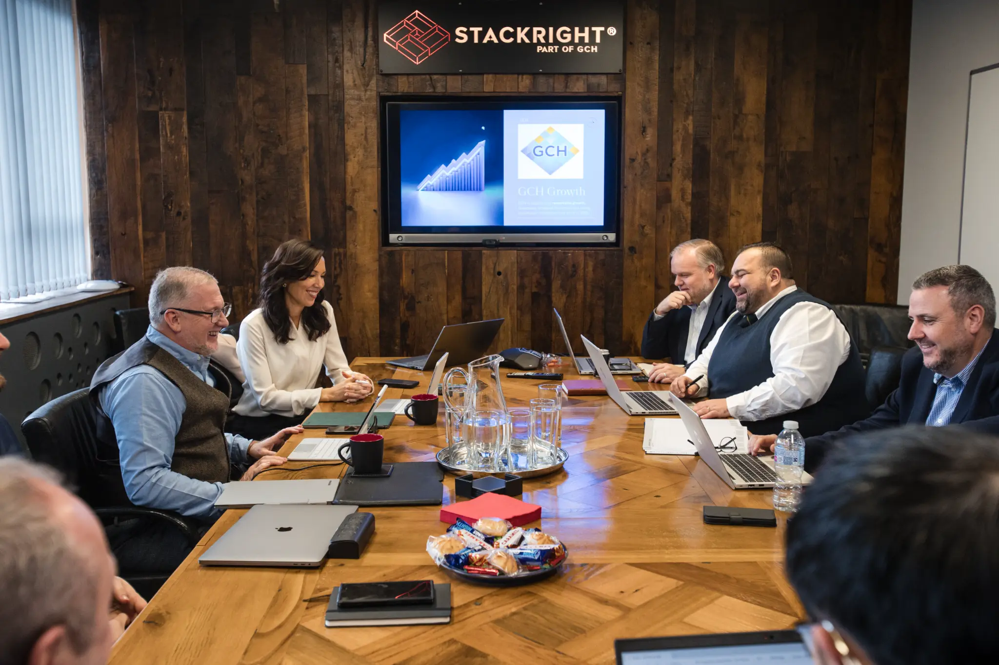 GCH leadership team in boardroom smiling